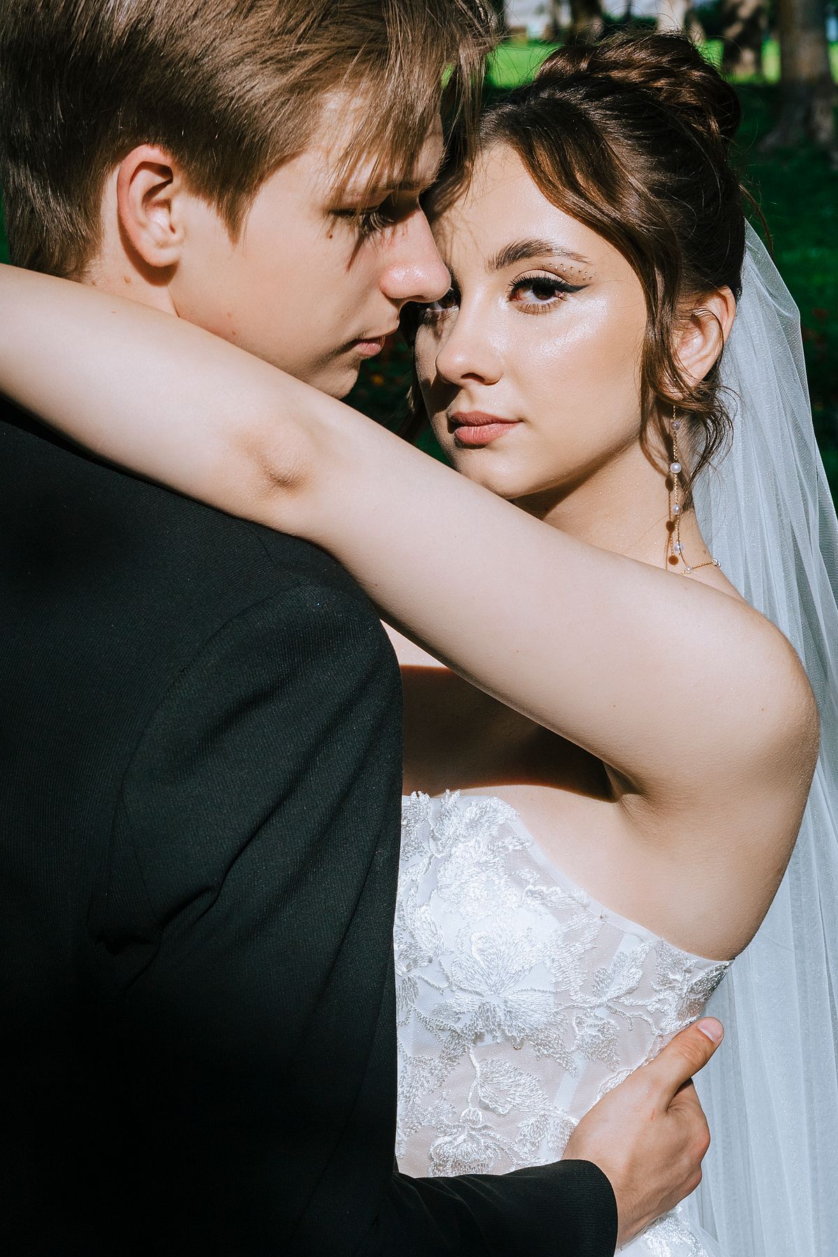 Wedding couple embracing outdoors